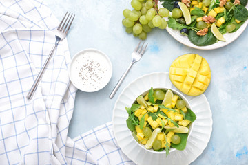 Tasty mango salad on table
