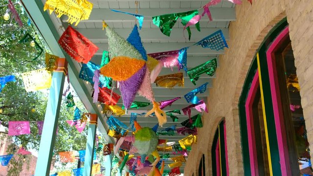 Traditional "papel picado" decorations and pinatas on the streets of San Antonio, Texas