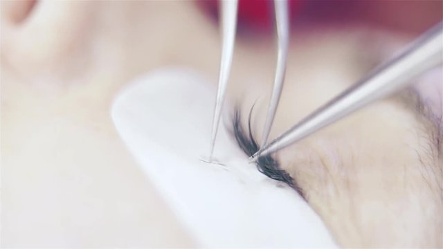 Gluing false Eyelashes macro shot