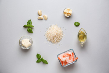Raw ingredients for risotto on light background