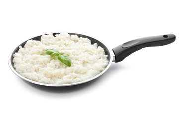 Frying pan with tasty risotto on white background