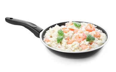 Frying pan with tasty risotto on white background