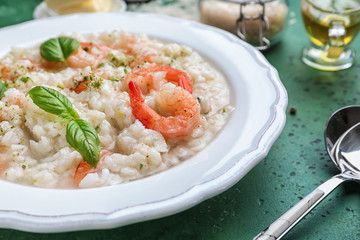 Plate with tasty risotto on table