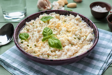 Plate with tasty risotto on table