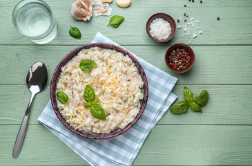 Plate with tasty risotto on wooden table