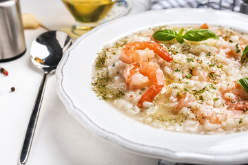Plate with tasty risotto on table