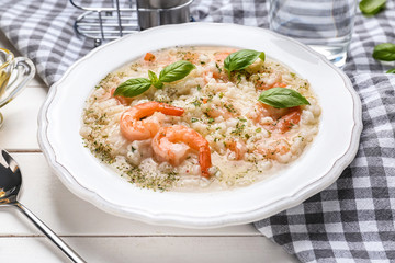 Plate with tasty risotto on table