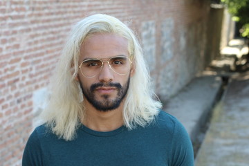 Ethnic man with blonde dyed long hairstyle 