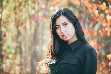 Female beauty portrait surrounded by vivid foliage. Dreamy beautiful girl with long natural black...