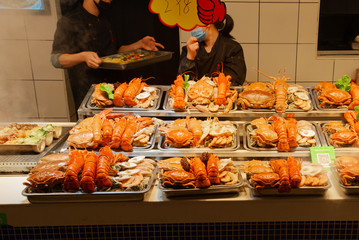 Fresh cooked seafood dishes with clam, crayfish, lobster in the kitchen of China, Xiamen
