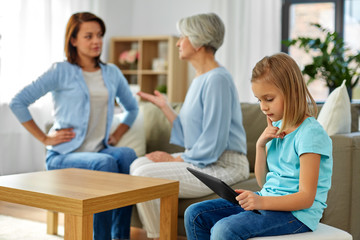 family, generation and parenting concept - daughter with tablet computer, mother and grandmother arguing at home