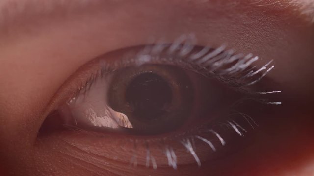 Digital animation shoot of greenish eye with white mascara with the reflection of person reaching out his hands.
