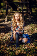 Outdoor fall portrait of girl with hat and jeans wear.