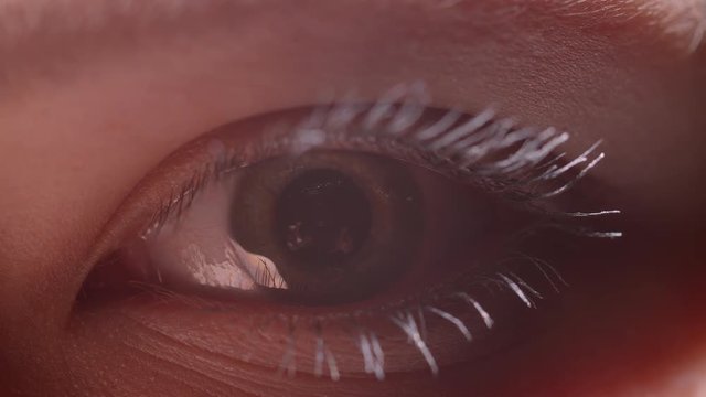 Digital animation shoot of green eye with white mascara with the reflection of person stretching his hands.