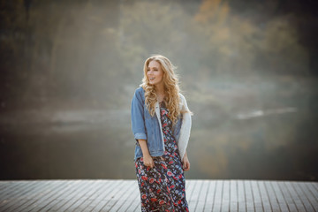 Fototapeta premium Outdoor fall portrait of girl with hat and jeans wear.