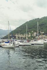 Fototapeta na wymiar Many yachts and boats in the harbor of Como, Italy.