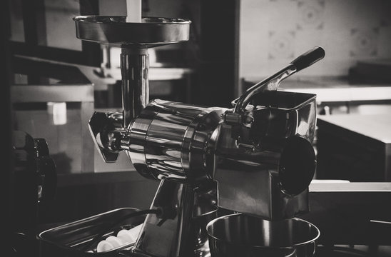 Close-up view of modern meat grinder. Black and white.