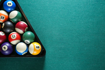 Billiard balls in triangle rack on table