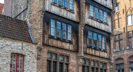 Bruges, Belgium - December 15, 2018: Exterior of medieval house on The Rozenhoedkaai (Quay of the Rosary). It is the hotel where 'In Bruges' was shot. Cityscape of Bruges streets shot from the boat.