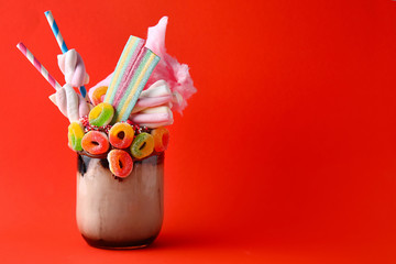 Delicious freak shake on color background