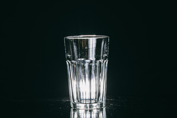 Empty glass on black background