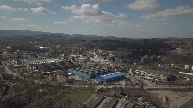 Gorlice, Poland - 3 9 2019: Industrial region of the Carpathian city. Top view of the refinery and auxiliary buildings. Video shot by drone or quadrocopter. Vanity of the day at the factory. Planning 