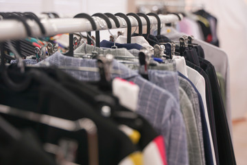 fashionable clothes hanging on hangers in the store. nobody.