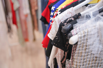 fashionable clothes hanging on hangers in the store. nobody.