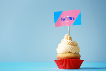 Tasty cupcake for Father's Day on grey background