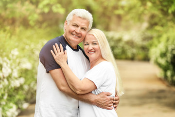 Naklejka premium Portrait of happy mature couple in park