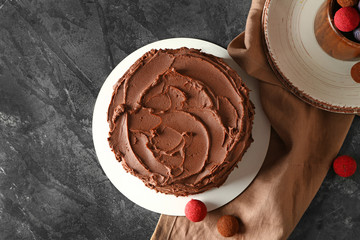 Tasty chocolate cake on grunge background