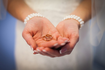 Wedding rings in hands of the bride. the girl offers to marry. marry me. wedding rings in the palms of the bride