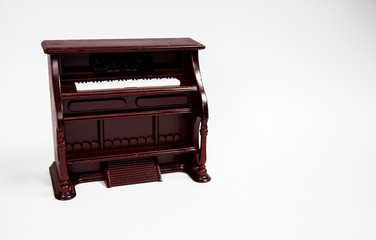 miniature classical piano keyboard instrument isolated on white background