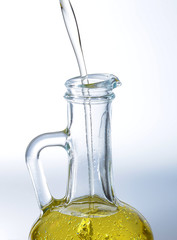 The neck of the glass container in which the vegetable oil is poured. Side view. Backlight.
