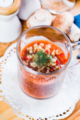 Tomato soup with fresh ingredients in a soup cup