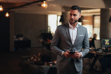 Portrait of attractive businessman in gray suit
