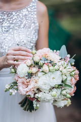 Wedding floristry in the hands of the bride.