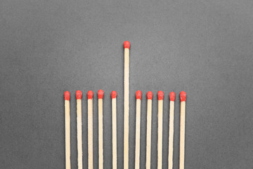 Matches on grey background. Concept of uniqueness