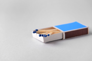 Box with matches on light background