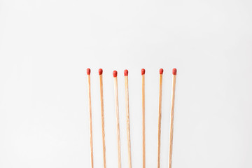 Many fireplace matches on light background
