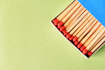 Box with matches on color background