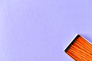 Box with matches on color background