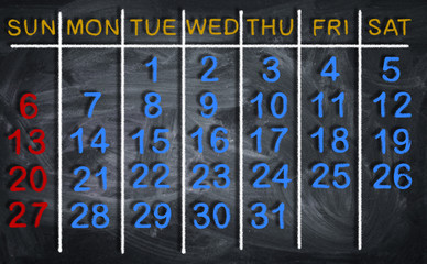 Calendar for the month on chalkboard background.