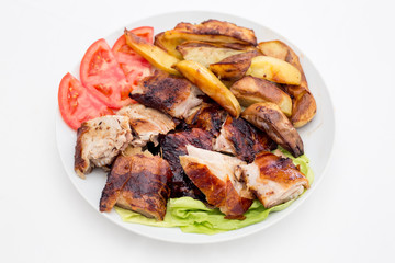 Pecenje with tomato salad and potatoes in restaurant