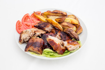 Pecenje with tomato salad and potatoes in restaurant