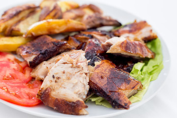 Pecenje with tomato salad and potatoes in restaurant