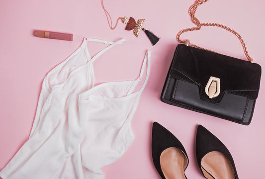 Stylish feminine accessories flat lay on pibk background