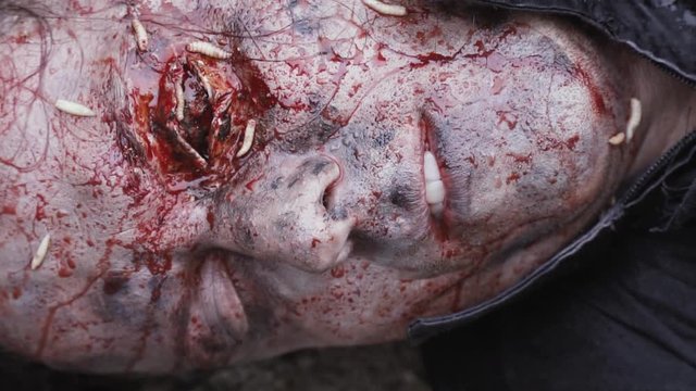 Close up of a scary corpse face with maggots on it