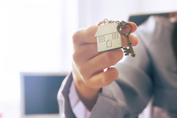 Closeup housing key chain on woman's hand.