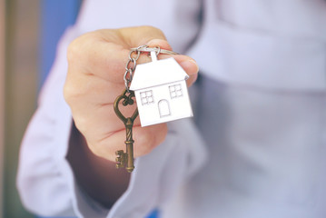 Closeup housing key chain on woman's hand.